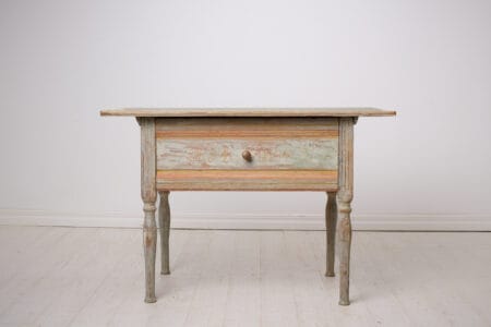 Antique folk art table from Sweden dated 1862. Made by hand in solid pine with the original first layer of paint. The table is rectangular with a large drawer