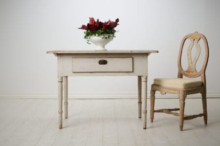 Antique folk art table in empire style from northern Sweden. This country house furniture is made around 1840 to 1850 with a frame in solid pine.