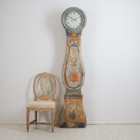 Antique long case clock from Sweden dated 1809 with unusual, original decor. Frame made by hand in solid pine with the original first layer of paint