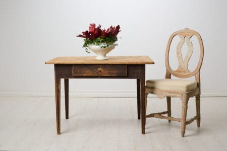 Antique country home table from Sweden. The table is made around 1840 and has a straight shape with tapered legs and a large drawer.