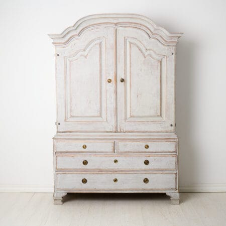 Genuine Swedish rococo cabinet from the late 1700s. The cabinet is made in two parts and very well crafted from solid pine around 1770 to 1780.