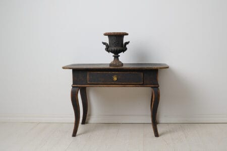 Early 1800s rococo table. The table is a country house furniture from northern Sweden made by hand in pine around 1820 to 1830.