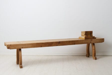Rustic antique long bench from the 1800s. The bench is a Swedish country house furniture made around 1840 in northern Sweden.