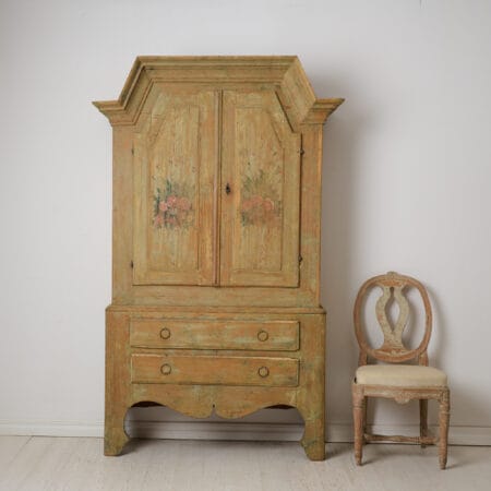 Rare folk art cabinet from northern Sweden made around 1820 to 1830. Made by hand in solid pine in two parts. Original