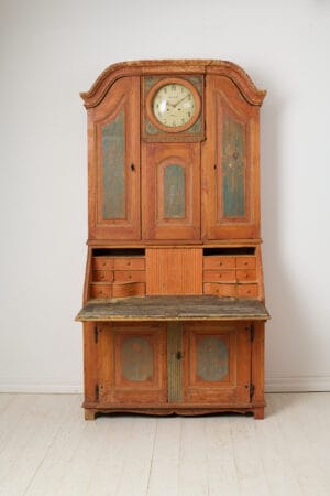 Rare antique rococo cabinet with a clock and secretary desk from the 19th century. Made by hand in Arbrå in northern Sweden