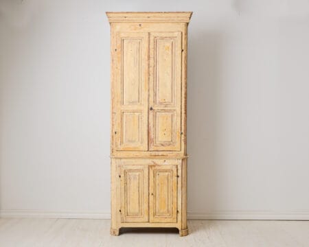 Antique tall narrow cabinet from the early 1800s. Made around 1810 to 1820 in northern Sweden. The frame is made by hand from solid pine in two parts.