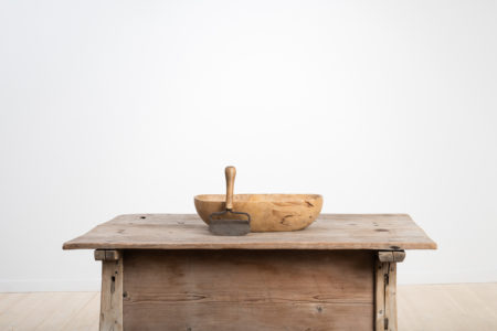 Wooden bowl with adjacent chopping knife in hand wrought iron