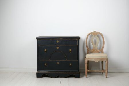 Antique Swedish chest of drawers in empire style from around 1840. The chest is made by hand in solid pine with three large, functional drawers.