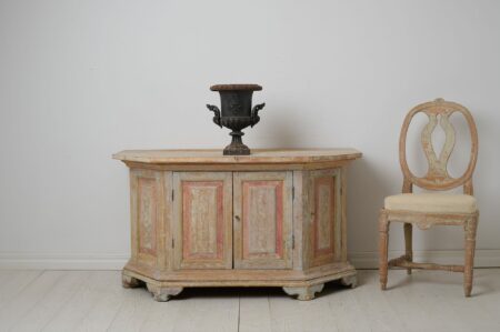 Antique Swedish sideboard from Norrbotten in northern Sweden made around 1820. The sideboard is low and wide and has an unusual shape with slanted corners,