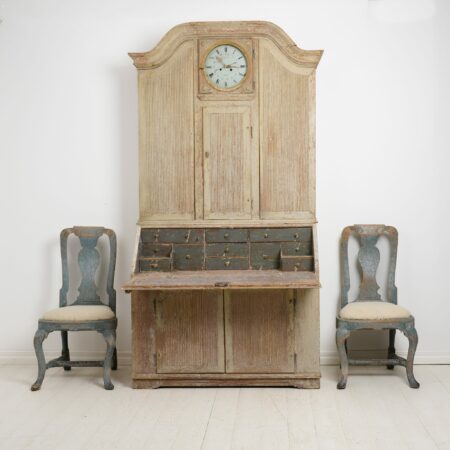 Rare Antique Secretary Cabinet in rococo with a clock. The cabinet is made by hand in solid pine around 1820 in northern Sweden. The cabinet is made in two parts
