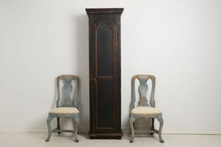 Antique Swedish narrow cabinet with a single door. The cabinet has an unusual shape, tall and narrow. Made by hand in northern Sweden around the 1840s