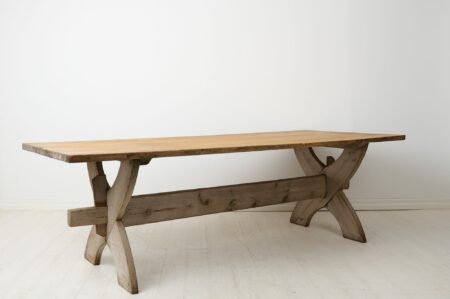 Large antique dining table or trestle table from northern Sweden made during the early 1800s. The table has a thick, solid table top