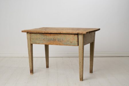 Rustic farm house table from northern Sweden made by hand in solid pine. The table is from around the 1840s and is in untouched original condition.