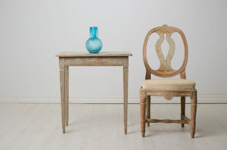 Small elegant antique table from the gustavian period in Sweden circa 1790. The table has a rectangular table top and straight, tapered legs.