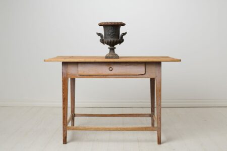 Antique Swedish country table in untouched condition. The table has a drawer and straight legs as well as original paint that shows the age