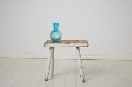 Antique folk art stool from northern Sweden. This charming stool is made by hand around 1860 in solid pine. Original paint with distress and patina.