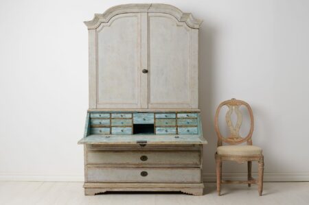 Antique rococo secretary cabinet from northern Sweden. The cabinet is from the rococo period and made by hand in two parts from solid pine
