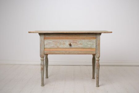 Antique folk art table from Sweden dated 1862. Made by hand in solid pine with the original first layer of paint. The table is rectangular with a large drawer