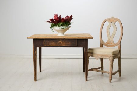 Antique country home table from Sweden. The table is made around 1840 and has a straight shape with tapered legs and a large drawer.