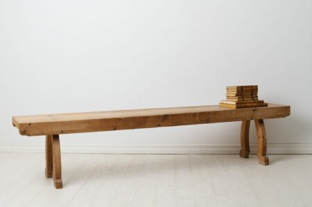 Rustic antique long bench from the 1800s. The bench is a Swedish country house furniture made around 1840 in northern Sweden.