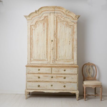 Swedish antique rococo cabinet from the 1700s. The cabinet is genuine Swedish and made by hand in solid pine in northern Sweden around 1780.