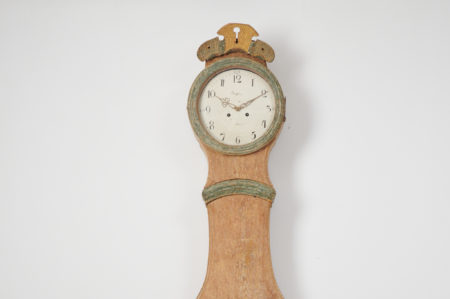 Classic long case clock in rococo shape from Sweden. The clock is made by hand from pine and has been hand-scraped down to the original paint