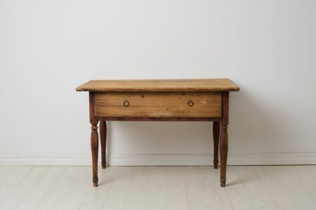 Genuine antique country table from the empire period around 1830. The table is made by hand from solid pine in northern Sweden.