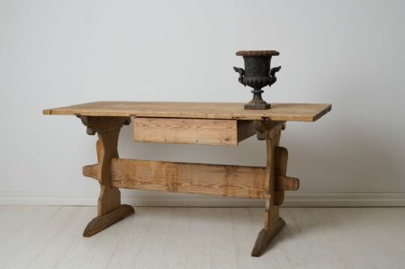 Primitive rustic trestle table in folk art. This table can be used as a dining table and is a classic Swedish folk art table that has never been painted.