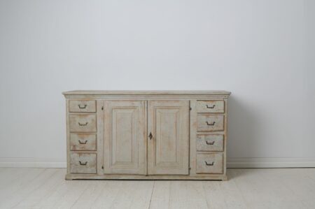 Early low and wide sideboard from 19th century Sweden. This genuine country house furniture was made around 1820 to 1830 in northern Sweden,