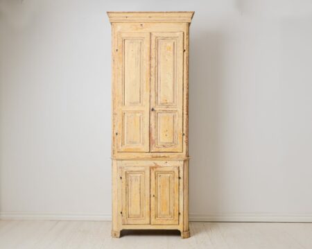 Antique tall narrow cabinet from the early 1800s. Made around 1810 to 1820 in northern Sweden. The frame is made by hand from solid pine in two parts.