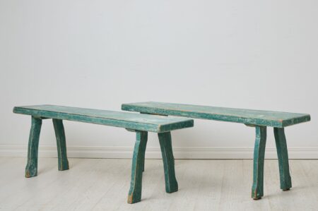 Pair of folk art benches from northern Sweden made around 1860. The benches are a unique pair and have the original first layer of paint