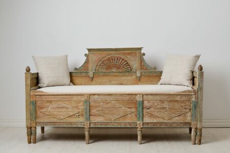 Antique country sofa or bench from the Swedish gustavian period, early 1800s. The model of sofa is often called "solsoffa" or sun-sofa