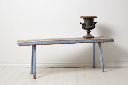Discover a Swedish antique country bench—handmade in pine, adorned with aged paint and historic graffiti. Embrace unique charm and character.