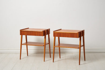 Swedish modern teak nightstands from the 1960s by Möbelfabriks AB, Carlssons & Co. The pair of nightstands have both a shelf and drawer.