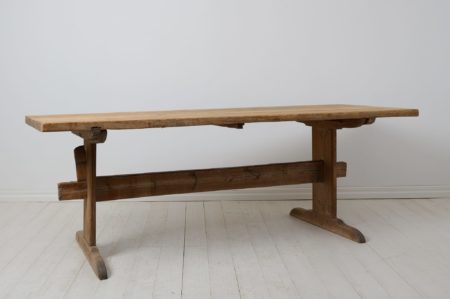 Large trestle dining table from northern Sweden. The table is a genuine antique made by hand in pine around 1820 to 1840